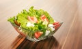 Mixed salat in a glass bowl isolated on white.