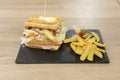 Mixed sandwich with salad, canned tuna, white asparagus, boiled egg, ham and cheese with grilled bread, garnished with fried