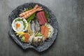 mixed sashimi plate in japanese restaurant on grey background