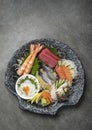 mixed sashimi plate in japanese restaurant on grey background