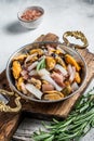 Mixed Seafood, variation of fresh mussels, clams, squid, octopus, shrimps and prawn in a skillet. White background. Top