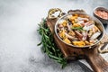 Mixed Seafood, variation of fresh mussels, clams, squid, octopus, shrimps and prawn in a skillet. White background. Top