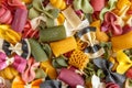 Mixed selection of dried pasta on wooden background. Macaroni scattered on a glass jar. Background. Close up Royalty Free Stock Photo