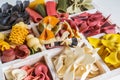 Mixed set of dry multi-colored Italian pasta on a white old wooden box. Background. Close up. Royalty Free Stock Photo