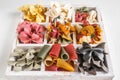 Mixed set of dry multi-colored Italian pasta on a white old wooden box. Background. Close up. Royalty Free Stock Photo