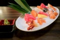 Mixed sliced fish sashimi on ice in white bowl. Sashimi Salmon Tuna Hamachi Prawn and Surf Calm set, raw fish, japanese food in Royalty Free Stock Photo