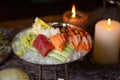 Mixed sliced fish sashimi and shrimps on ice in black bowl. Sashimi Salmon Tuna Hamachi Prawn and Surf Calm set, raw fish, japanes Royalty Free Stock Photo