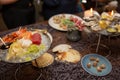 Mixed sliced fish sashimi and shrimps on ice in black bowl. Sashimi Salmon Tuna Hamachi Prawn and Surf Calm set, raw fish, japanes Royalty Free Stock Photo