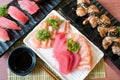 Mixed sliced fish sashimi in white plate. Sashimi Salmon and Tuna set with Tuna, flying fish roe caviar and Foie Gras closeup.