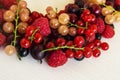 Mixed summer berries raspberry, blackcurrant, redcurrant, white currant, gooseberry, cherry on the white background.