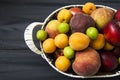 Mixed summer fruit pictures in a basket,White background with a basket of peaches, plums, apples, nectarines, apricot pictures