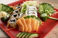 Mixed sushi roll and salmon sashimi Royalty Free Stock Photo