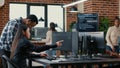 Mixed team of software developers analyzing source code pointing at screens comparing algorithm Royalty Free Stock Photo