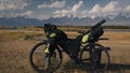 The mixed terrain cycle touring bike with bikepacking. The trip on multitrack bike, outdoor road in mountain snow capped Royalty Free Stock Photo