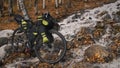 The mixed terrain cycle touring bike with bikepacking.The trip on bike, outdoor in magical autumn forest, river stream. Royalty Free Stock Photo