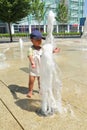 Toddler boy playing in water of fountain Royalty Free Stock Photo