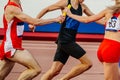 mixed track and field team running relay race 4 400 metres Royalty Free Stock Photo