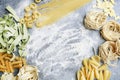 Mixed types and shapes of italian pasta on grey stone background Royalty Free Stock Photo