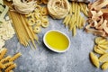 Mixed types and shapes of italian pasta on grey stone background Royalty Free Stock Photo