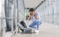 Mixed Up Luggage. Desperate man sitting near airport terminal with suitcase