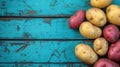 Mixed varieties of potatoes on weathered blue wooden table