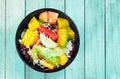 Mixed vegetable and fruit salad in black bowl Royalty Free Stock Photo