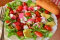 Mixed vegetable salad with crab sticks and avocado