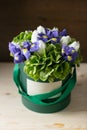 Mixed flowers . Bouquet of hydrangea, irises, tulips in a box on wooden table. copy space. Royalty Free Stock Photo