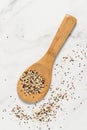 Mixed white, red and black quinoa grains on wooden spoon and pile scattered on marble table Royalty Free Stock Photo