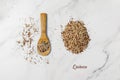 Mixed white, red and black quinoa grains on wooden spoon and pile scattered on marble table Royalty Free Stock Photo