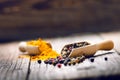 Mixed whole pepper on a wooden scoop. Natural old background. Concept of food, spice Royalty Free Stock Photo