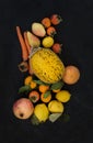 Mixed yellow orange fruit and veggies assortment, ingredients for smoothie. Melon, garnet, grapefruit, carrot, persimmon