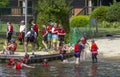 A mixed youth group with their adult supervisors as they dive and swim from a small jetty on the river at Henley on Thames