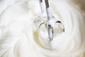 Mixer beaters partly emersed in whipped egg whites that have just been beaten until they are stiff Royalty Free Stock Photo