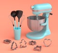 Mixer and metal cookie cutters with kitchen utensil for making cookies on coral Royalty Free Stock Photo