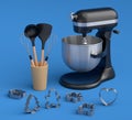 Mixer and metal cookie cutters with kitchen utensil for making cookies on blue Royalty Free Stock Photo