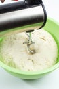 Mixer mixes the dough in a large cup on white, dough preparation