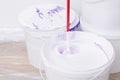 mixer mixes purple color in white paint