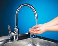 Mixer tap with water and washing hands Royalty Free Stock Photo