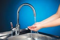 Mixer tap with water and washing hands Royalty Free Stock Photo