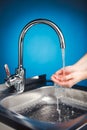 Mixer tap with water and washing hands Royalty Free Stock Photo