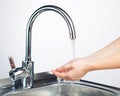 Mixer tap with water and washing hands Royalty Free Stock Photo