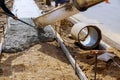 Truck pouring cement concrete casting on reinforcing metal bars of sidewalk Royalty Free Stock Photo