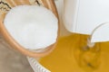 Mixer whip egg yolk with sugar - close-up. Mixer whisk eggs and sugar.