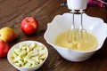 Mixing Batter or dough for apple-pear cake or muffin or pancake. Close up in wooden table c ingredients