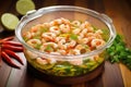 mixing bowl with raw shrimp in chili lime sauce Royalty Free Stock Photo