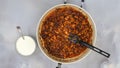 Mixing chopped chicken fillet and paprika on frying pan, close up view from above. Sour cream chicken paprika recipe