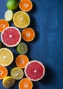 Mixing of citrus fruits on a blue background, top view. Oranges, grapefruit, tangerine, lime, lemon - organic fruits, vegetarian h