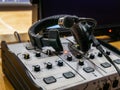 Mixing console and headset at the workplace of a sports commentator