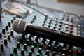 Mixing console and a new microphone close-up with a small depth of field. Royalty Free Stock Photo
